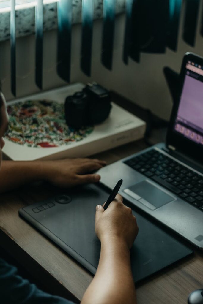 pexels-photo-16313658 A creative workspace featuring a drawing tablet, laptop, and camera enhances productivity.