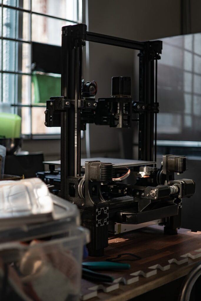 pexels-photo-19987744 A detailed view of a 3D printer in a workshop with ambient light.